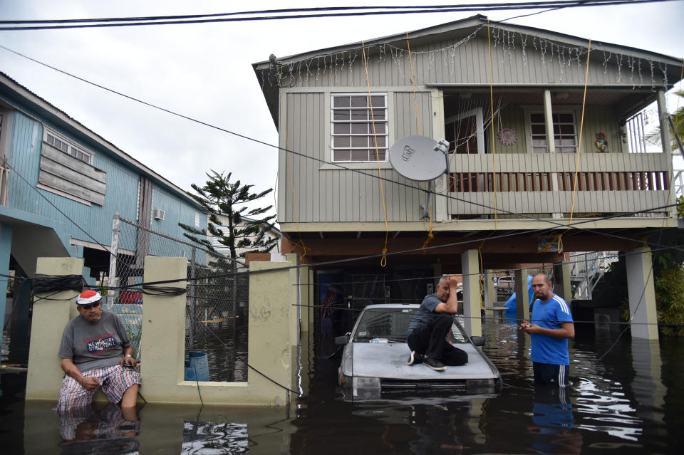 Inhabitants stand in floodwater in Cataño, Puerto Rico, Sept. 21, 2017. (Photo: Hector Retamal/AFP/Getty Images)