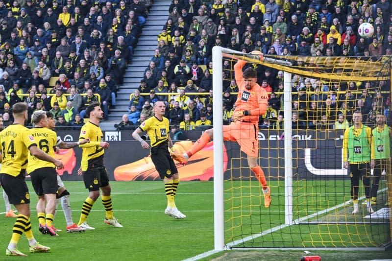 Dortmund goalkeeper Gregor Kobel deflects the ball over the goal during the German Bundesliga soccer match between Borussia Dortmund and Bayer Leverkusen at Signal Iduna Park. Bernd Thissen/dpa