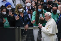 Pope Francis leaves at the end of his weekly general audience in the Paul VI Hall, at the Vatican, Wednesday, April 6, 2022. (AP Photo/Alessandra Tarantino)