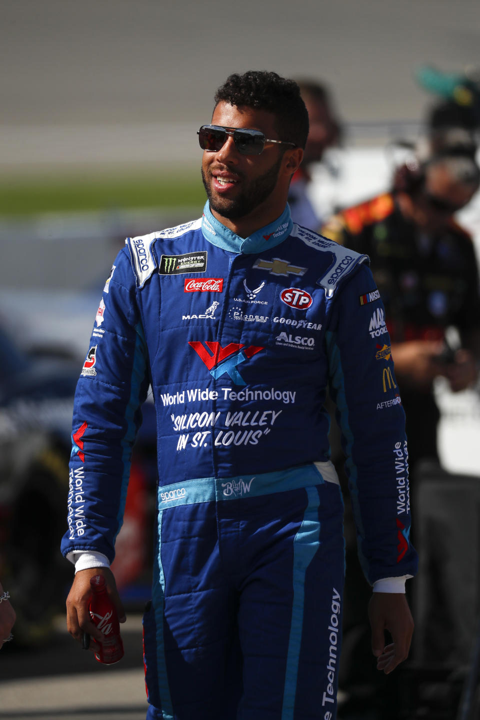 Bubba Wallace watches qualifications for a NASCAR Cup Series auto race at Michigan International Speedway in Brooklyn, Mich., Friday, Aug. 9, 2019. (AP Photo/Paul Sancya)