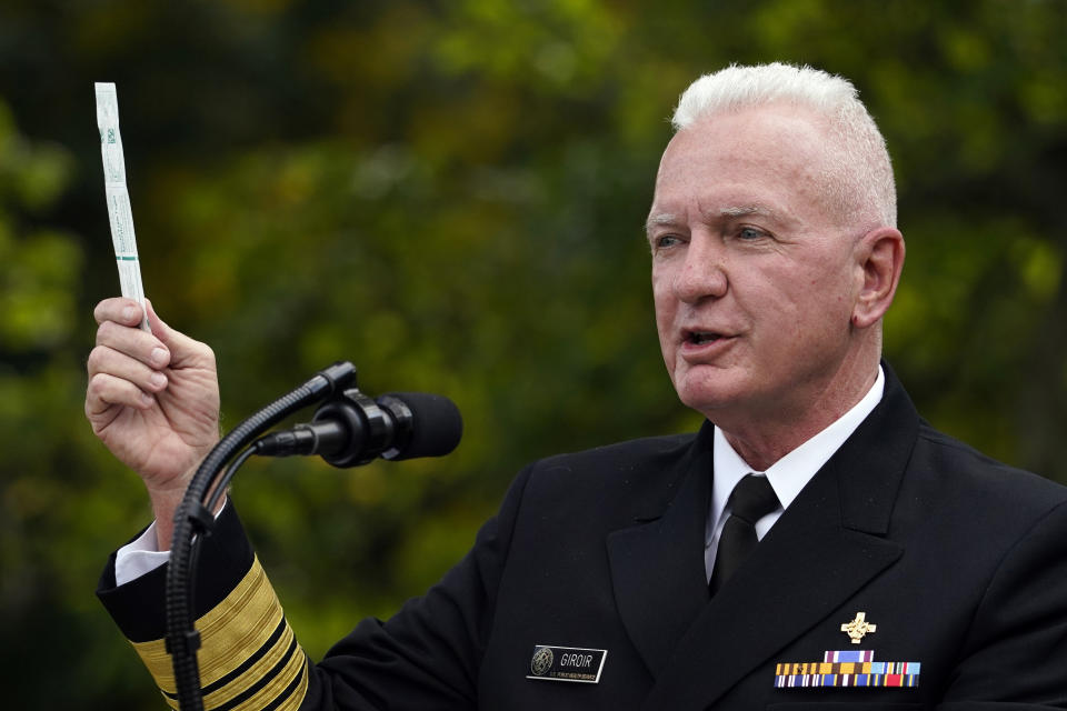 FILE - In this Sept. 28, 2020, file photo, Adm. Brett Giroir, assistant secretary of Health and Human Services, holds a swab manufactured by Puritan Medical Products as he talks about a new COVID-19 test during a event with President Donald Trump about coronavirus testing in the Rose Garden of the White House in Washington. A multi-state coronavirus surge in the countdown to Election Day has exposed a clear split between President Donald Trump’s bullish embrace of a return to normalcy and urgent public warnings from the government’s top health officials. (AP Photo/Evan Vucci, File)