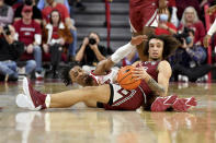 Arkansas guard Stanley Umude, rear, tries to get the ball from South Carolina guard Devin Carter (23) during the first half of an NCAA college basketball game Tuesday, Jan. 18, 2022, in Fayetteville, Ark. (AP Photo/Michael Woods)