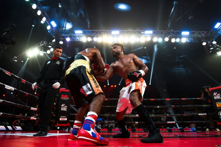 In this photograph taken on July 21, 2017, boxer Venkat Naik (left) with the Bahubali Boxers is punched by Maratha Yoddhas' Sandeep Singh during a Super Boxing League event in New Delhi