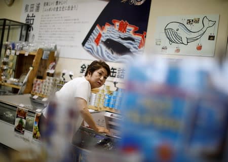 Yachiyo Ichihara, 72, checks local whale products at a roadside store named WA-O! in Minamiboso