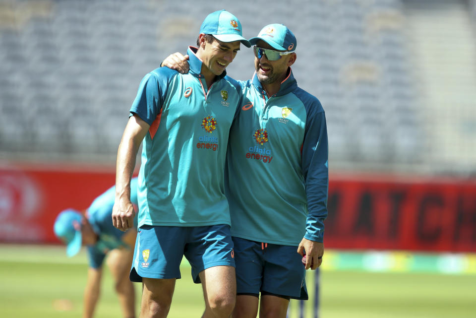 Australia's Pat Cummins, left, and Nathan Lyon react ahead of play on the first day of the first cricket test between Australia and the West Indies in Perth, Australia, Wednesday, Nov. 30, 2022. (AP Photo/Gary Day)