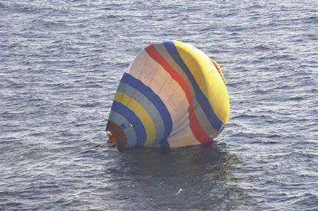 A hot-air balloon drifting on the ocean is seen in the East China Sea near the disputed isles known as Senkaku isles in Japan and Diaoyu islands in China, in this handout photo taken and released by the 11th Regional Coast Guard Headquarters-Japan Coast Guard January 2, 2014. REUTERS/11th Regional Coast Guard Headquarters-Japan Coast Guard/Handout via Reuters