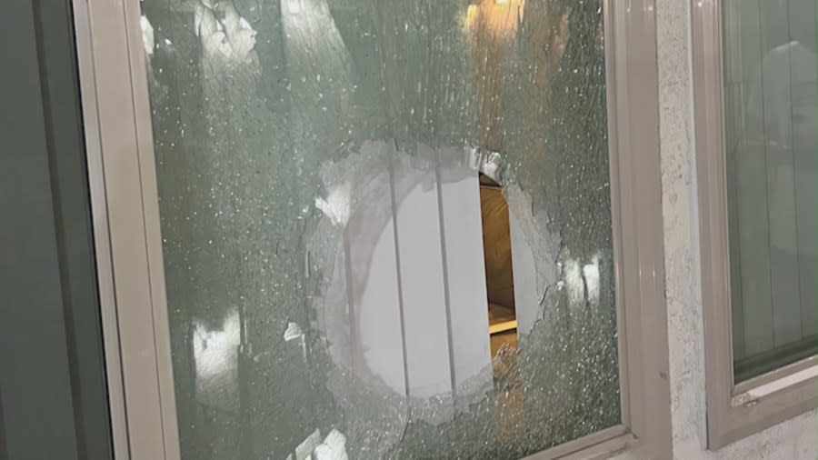 A broken window of one of the units in the Gladys Avenue condo complex in Long Beach. Residents say one occupant has been terrorizing them for months. April 6, 2024. (KTLA)