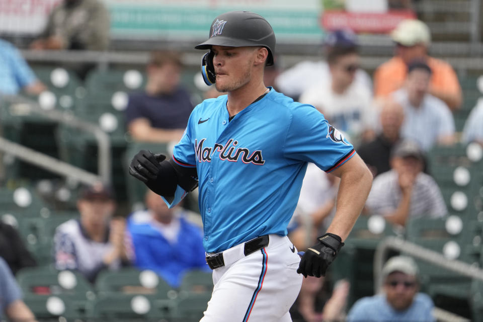 Miami Marlins' Griffin Conine arrives home after hitting a solo home run during the third inning of a spring training baseball game against the Washington Nationals Wednesday, March 6, 2024, in Jupiter, Fla. (AP Photo/Jeff Roberson)