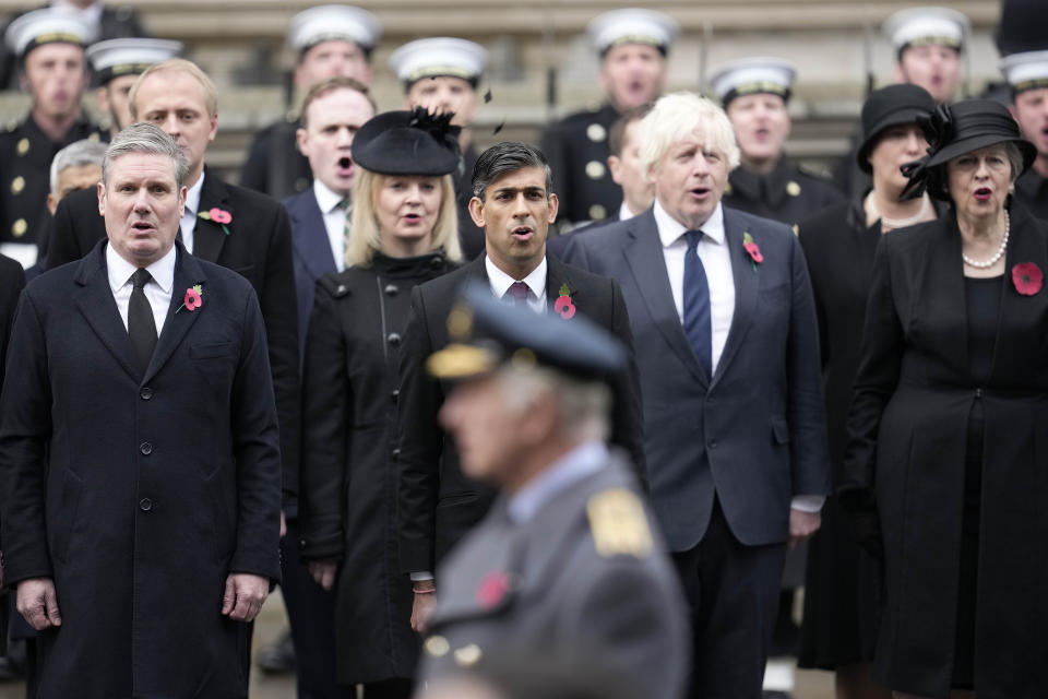 FILE - Britain's Prime Minister Rishi Sunak, centre, stands with Labour Party leader Keir Starmer, left, former Prime Ministers Liz Truss, fourth right, Boris Johnson, second right, and Theresa May, right, to attend the Remembrance Sunday ceremony at the Cenotaph on Whitehall in London, Sunday, Nov. 12, 2023. (AP Photo/Kin Cheung, Pool, File)