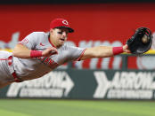 Cincinnati Reds first baseman Spencer Steer makes a diving stop on a ball hit by Texas Rangers Nathaniel Lowe in the third inning of a baseball game Sunday, April 28, 2024, in Arlington, Texas. (AP Photo/Richard W. Rodriguez)