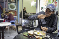 A man eats, in a restaurant in central Dakhla, Western Sahara, Monday, Dec. 21, 2020. U.S. plans to open a consulate in Western Sahara mark a turning point for the disputed and closely policed territory. U.S. recognition of Morocco’s authority over the land frustrates indigenous Sahrawis seeking independence. But others see the future U.S. consulate as a major boost for Western Sahara cities like Dakhla. (AP Photo/Mosa'ab Elshamy)