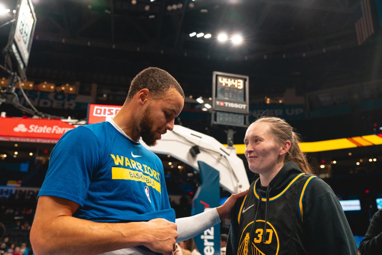 Golden State star Steph Curry meets with Oklahoma women's basketball guard Taylor Robertson on Monday at Paycom Center before the Warriors' game against the Oklahoma City Thunder.