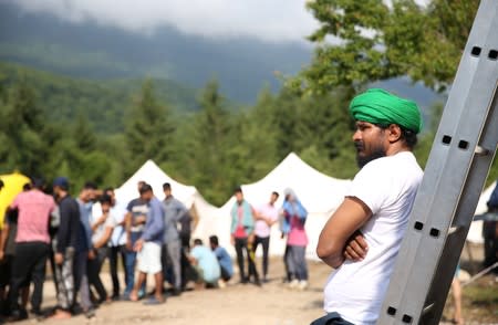 Migrants wait for breakfast in camp Vucjak in Bihac