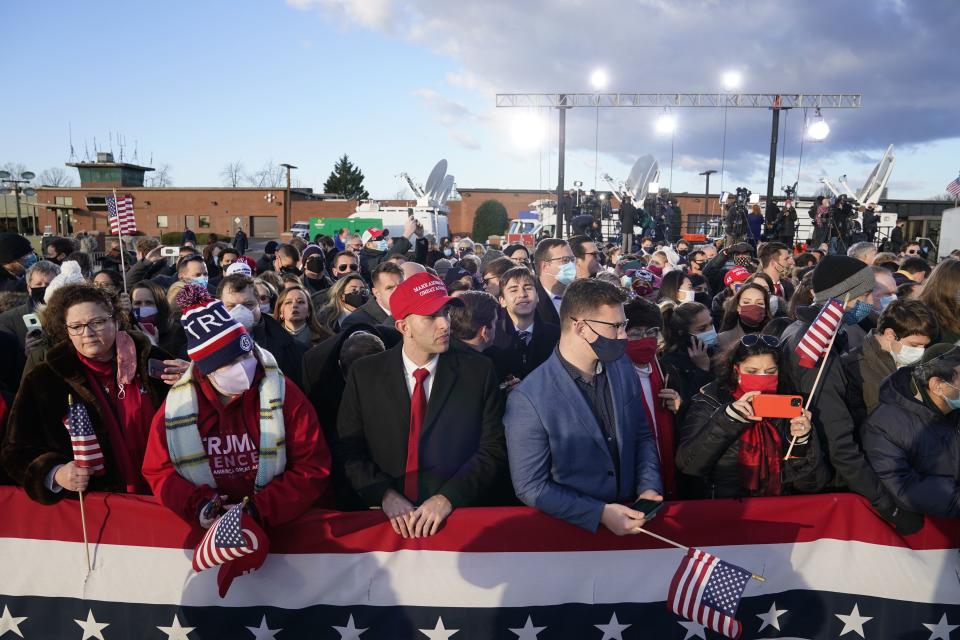 Supporters of US President Donald Trump gather at Joint Base Andrews in Maryland for Trump's departure on January 20, 2021. - President Trump travels to his Mar-a-Lago golf club residence in Palm Beach, Florida, and will not attend the inauguration for President-elect Joe Biden. (Photo by ALEX EDELMAN / AFP) (Photo by ALEX EDELMAN/AFP via Getty Images)