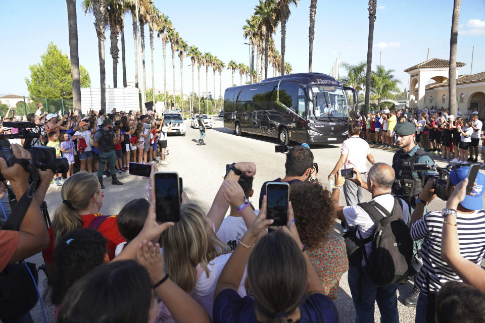 Fans welcome the Spanish women's team bus as they arrive for a training session in Oliva, Spain, Wednesday, Sept. 20, 2023. Most of Spain's World Cup-winning players have ended their boycott of the women's national team after the government intervened to help shape an agreement that was expected to lead to immediate structural changes at the country's soccer federation. (AP Photo/Alberto Saiz)