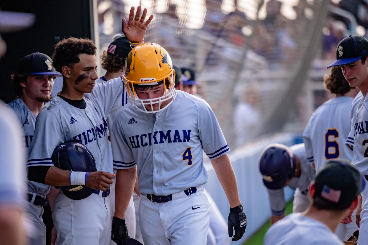 Hickman's Braden Hemmer (4) gets praised from teammate Kaelin Tindall (left) after scoring a run in the Kewpies' 3-0 win over Battle on Tuesday, May 10, 2022.