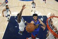 Denver Nuggets guard Jamal Murray (27) goes up for a shot against the Minnesota Timberwolves during the first half of Game 3 of an NBA basketball second-round playoff series Friday, May 10, 2024, in Minneapolis. (AP Photo/Abbie Parr)