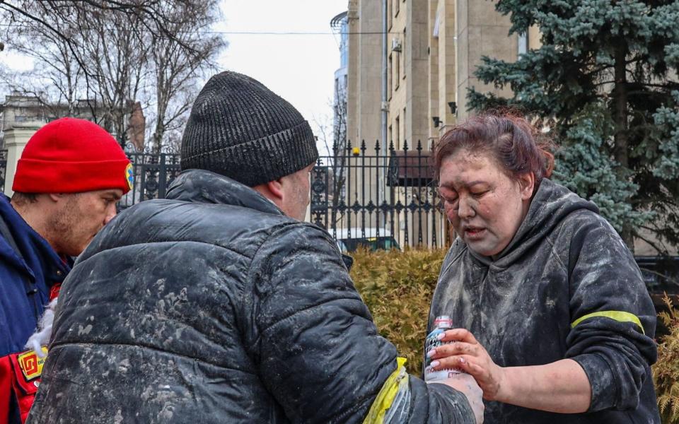 A woman injured by airstrikes n Kharkiv is given water and aid - Sergey Dolzhenko/ Shutterstock