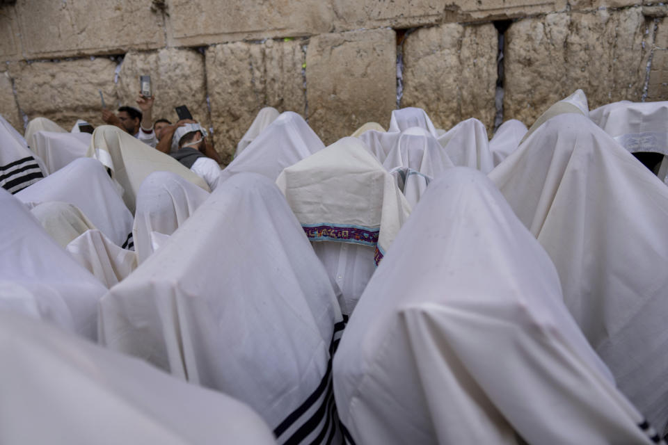 Israeli ultra-Orthodox worshippers pray during the Jewish holiday of Sukkot at the Western Wall, the holiest site where Jews can pray in Jerusalem's Old City, Wednesday, Oct. 4, 2023. (AP Photo/Ohad Zwigenberg)