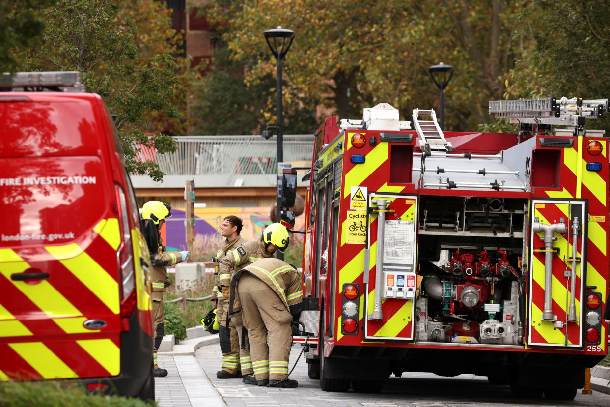 Members of the London Fire Brigade are seen outside a tower block following a fire inside an apartment on the 18th floor, in south London, Britain, November 4, 2021. REUTERS/Henry Nicholls