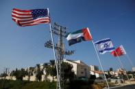 The flags of the U.S., United Arab Emirates, Israel and Bahrain flutter along a road in Netanya