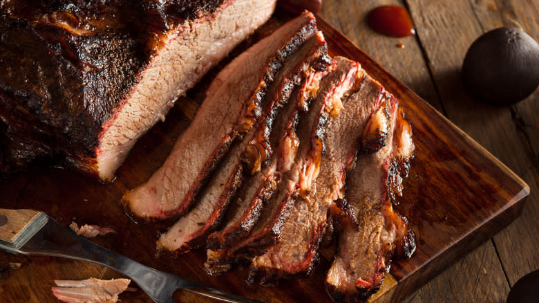 sliced brisket on wooden platter