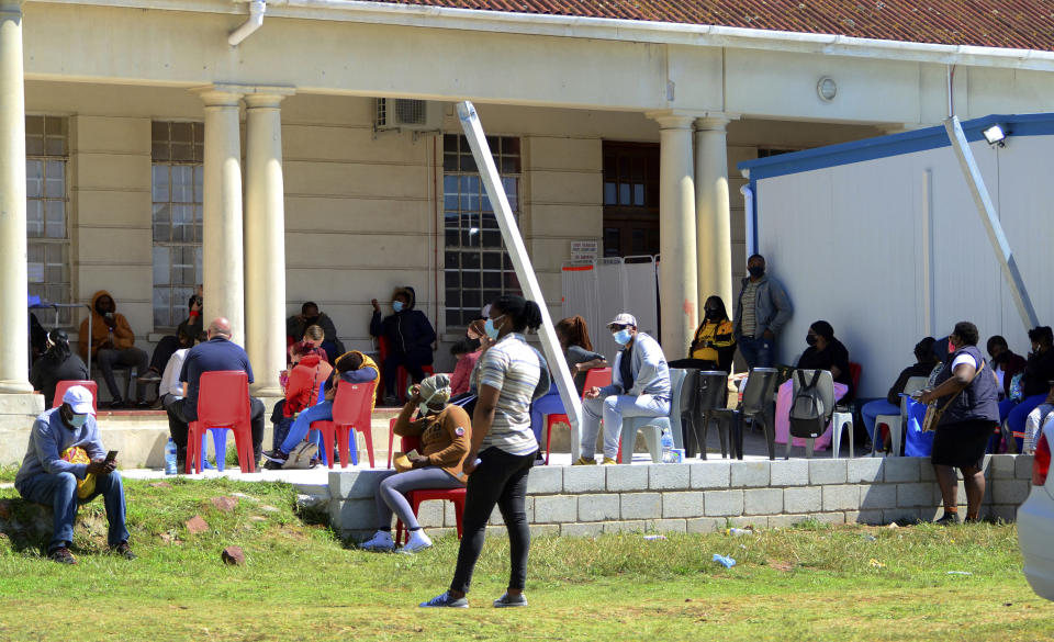 People queue to be tested for COVID-19 at the Livingstone Hospital in Port Elizabeth, South Africa, Friday, Nov. 13, 2020. The African continent has surpassed 2 million confirmed cases as health officials warn of infections starting to creep up again into a second surge. (AP Photo/Theo Jeptha)