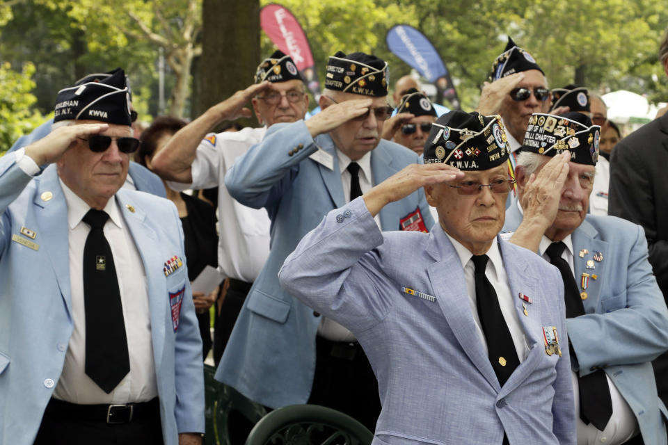 Korean War Veterans salute as the honor guard presents the American flag at the Korean War memorial at Battery Park in New York, Friday, July 27, 2018. Korean War veterans have something extra to celebrate as they mark the 65th anniversary of the armistice that ended combat. (AP Photo/Stephen Groves)