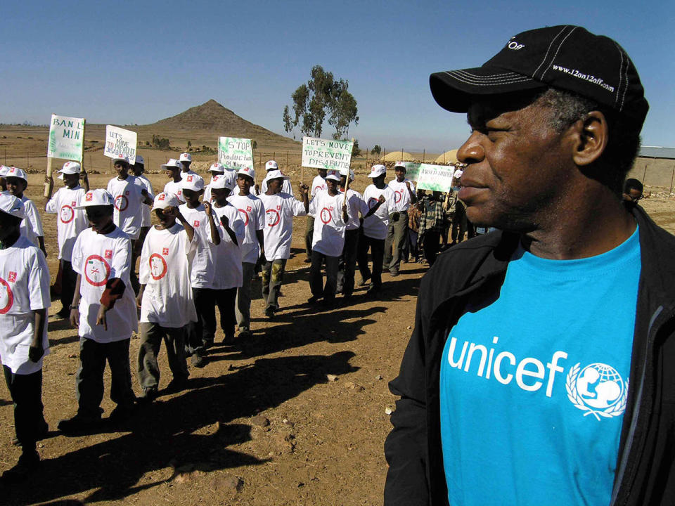 UNICEF Goodwill Ambassador Danny Glover meets young landmine survivors in Ethiopia in 2004.  / Credit: GUILLAME BONN/AFP via Getty Images