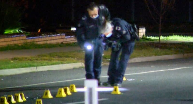 Two police officers at the scene of the crash in Kangaroo Flats, a suburb of Bendigo.