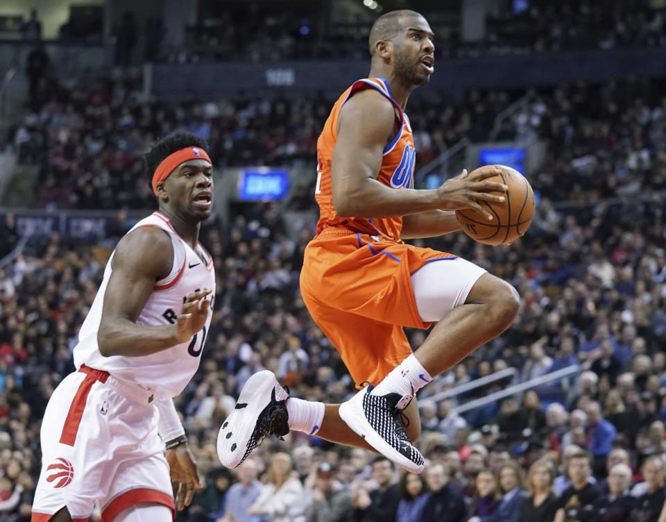 Oklahoma City Thunder Chris Paul (3) drives to the basket through the defense of Toronto Raptors Terence Davis II (0) during fourth quarter NBA basketball action in Toronto on Sunday, Dec. 29, 2019. (Hans Deryk/The Canadian Press via AP)