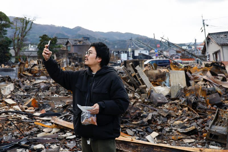 Japanese lacquer artist Kohei Kirimoto searches for his cats, in the aftermath of an earthquake, in Wajima