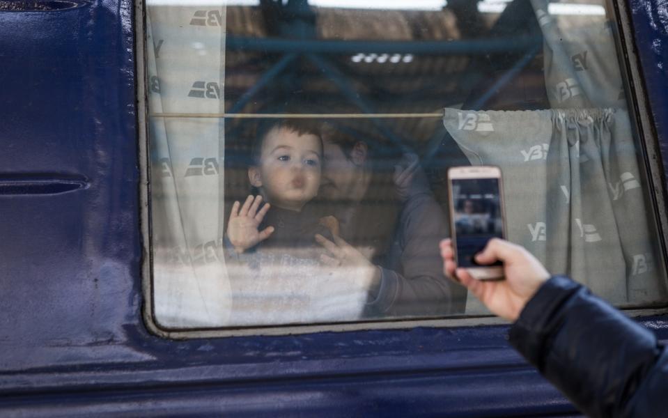 Refugees coming mostly from the Mariupol area and arriving with the last humanitarian convoy consisting of 15 buses, take the train to the Zaporizhia station to continue their journey west in Zaporizhia, Ukraine on March 23, 2022. - Anadolu Agency/Anadolu
