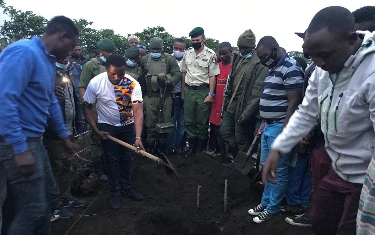 Park rangers burying their colleague, Burhani Abdou Surumwe, who was killed in the ambush - REUTERS