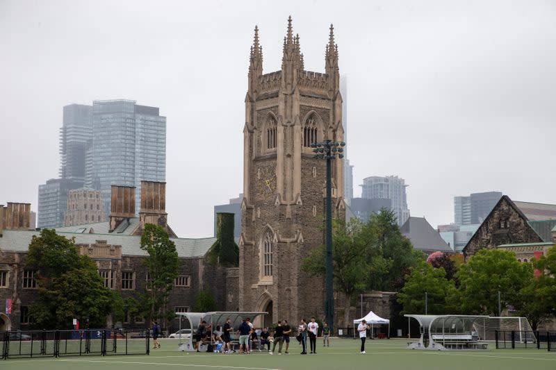 Students walk on the grounds of the University of Toronto in Toronto