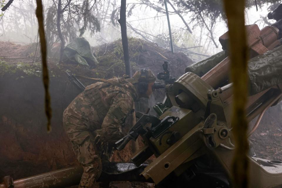 A Ukrainian paratrooper prepares to fire an L119 howitzer towards Russian positions at a frontline in the Luhansk region (AFP via Getty Images)