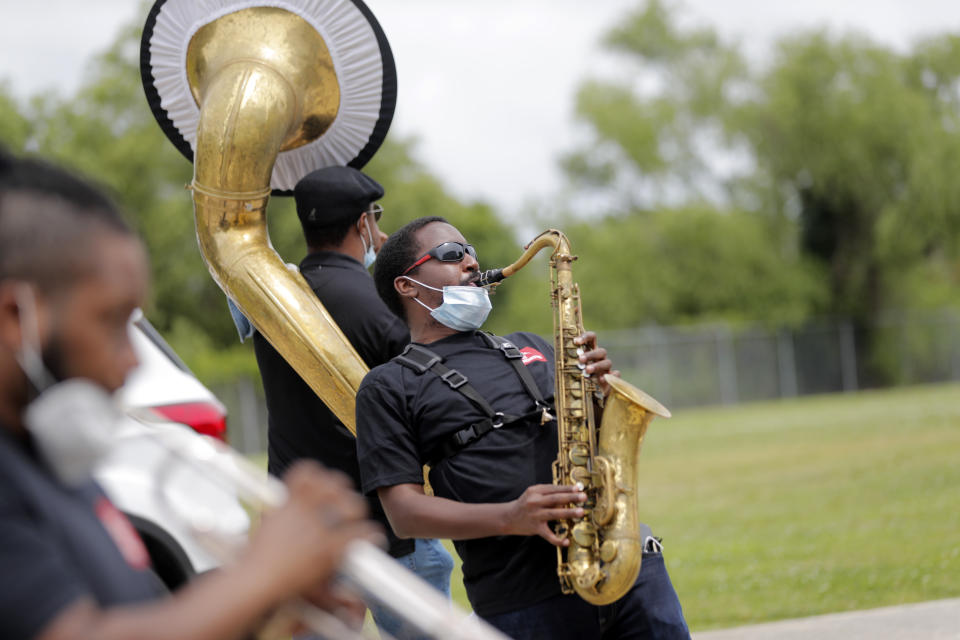 Members of the New Orleans Jazz Orchestra serenade healthcare workers at New Orleans East Hospital, as a tribute for their care of COVID-19 patients, outside the hospital in New Orleans, Friday, May 15, 2020. A New York woman collaborated with the New Orleans Jazz Orchestra to put on what she calls a stimulus serenade to give moral support to front-line hospital workers and COVID-19 patients in New Orleans. (AP Photo/Gerald Herbert)