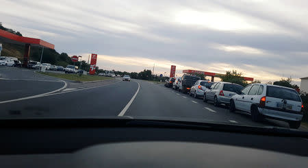 Cars and trucks line up for fuel in Albufeira, Portugal April 16, 2019 in this still image taken from social media video. TWITTER / @PENSADORZAROLHO/via REUTERS