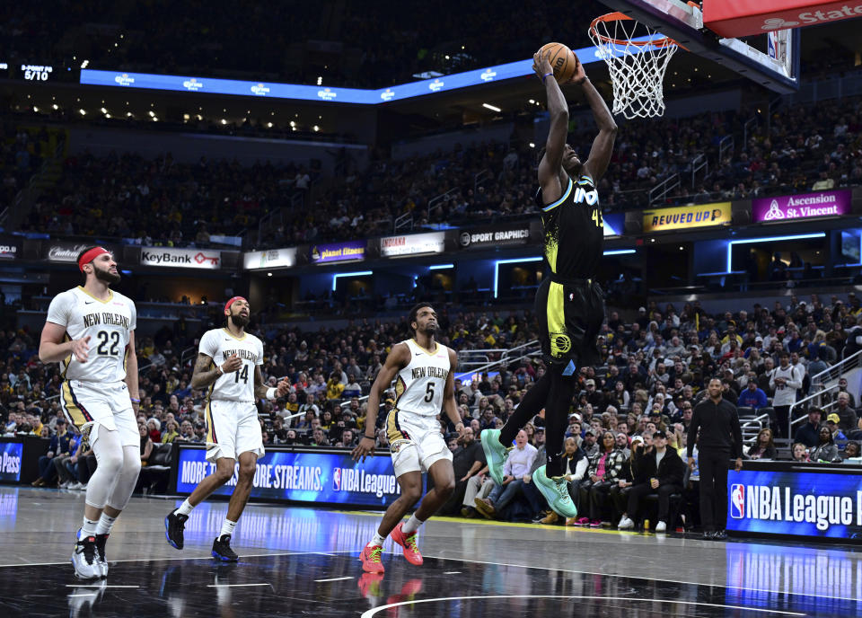 Indiana Pacers forward Pascal Siakam (43) dunks while New Orleans Pelicans forward Larry Nance Jr. (22), forward Brandon Ingram (14) and forward Herbert Jones (5) watch during the first half of an NBA basketball game Wednesday, Feb. 28, 2024, in Indianapolis. (AP Photo/Marc Lebryk)