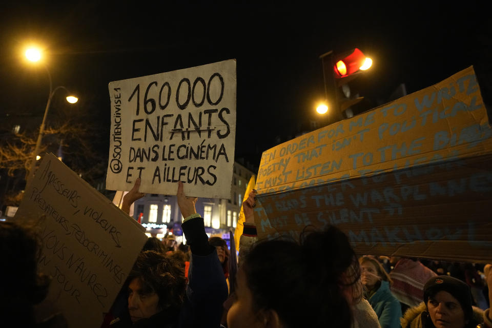 Demonstrators hold placards outside the Olympia theater before the Cesar Awards ceremony, France's version of the Oscars, Friday, Feb. 23, 2024 in Paris. As French cinema basks in Academy Awards attention, actors who allege they were teenage victims of sexual and physical abuse by directors decades older than them are shining the light on the repulsive underside of the country's industry. The latest step in the #MeToo movement could come at the French cinema awards. (AP Photo/Michel Euler)