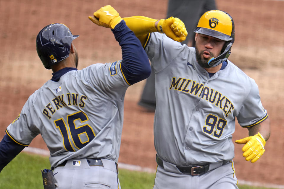 Milwaukee Brewers' Gary Sánchez (99) celebrates with Blake Perkins after hitting a two-run home run off Pittsburgh Pirates relief pitcher Aroldis Chapman during the eighth inning of a baseball game in Pittsburgh, Thursday, April 25, 2024. The Brewers won 7-5. (AP Photo/Gene J. Puskar)