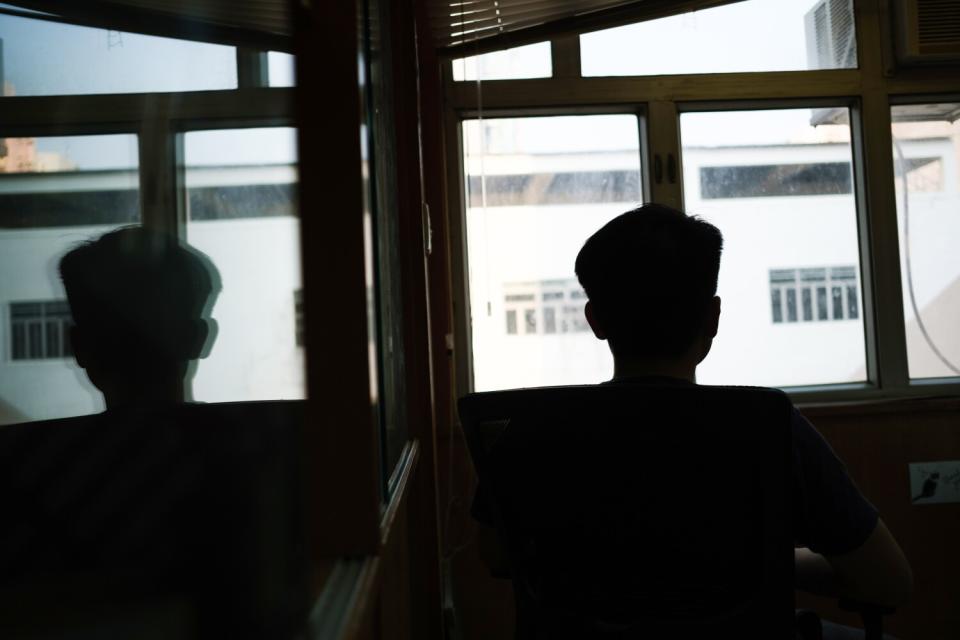 A silhouette of a man near a window