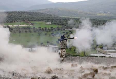 A Turkish-backed Free Syrian Army fighters fires a projectile in Rajo, March 3. REUTERS/Khalil Ashawi