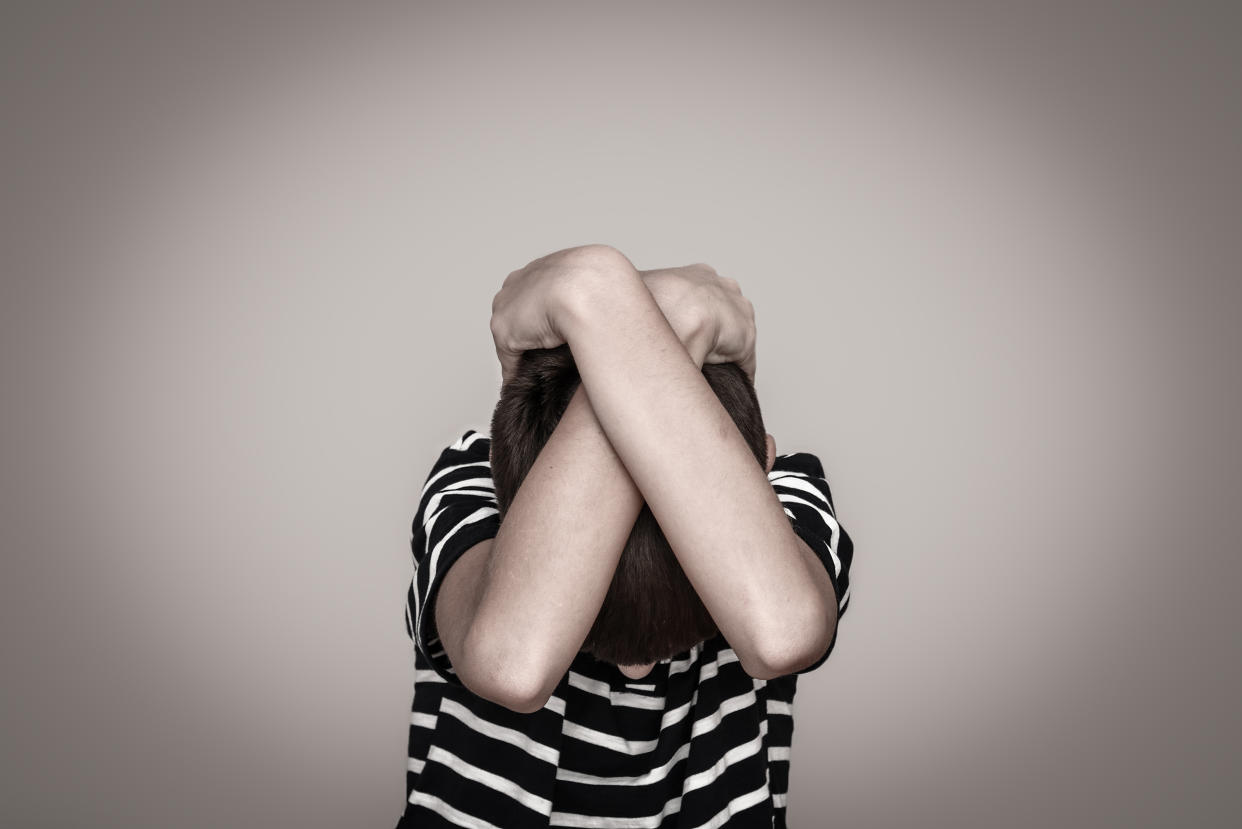 A boy covering his head. (PHOTO: Getty Images)