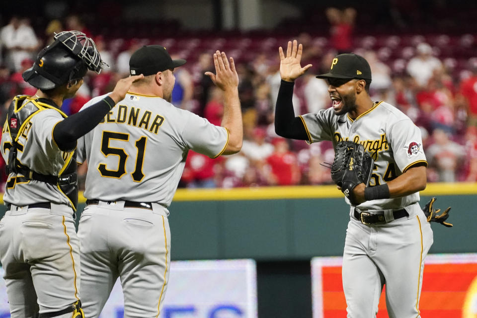 Pittsburgh Pirates' Joshua Palacios, right, celebrates with relief pitcher David Bednar, second from left, following their victory over the Cincinnati Reds in a baseball game, Friday, Sept. 22, 2023, in Cincinnati. (AP Photo/Joshua A. Bickel)