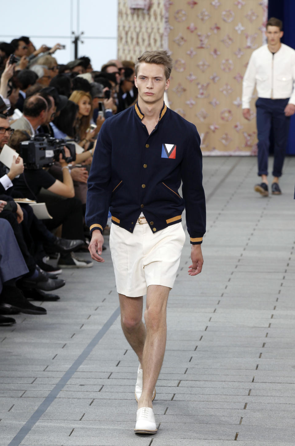 <p>Model wears a nautical-inspired outfit featuring a fitted bomber jacket and white shorts, looking ready to set sail. (Photo: Getty Images) </p>