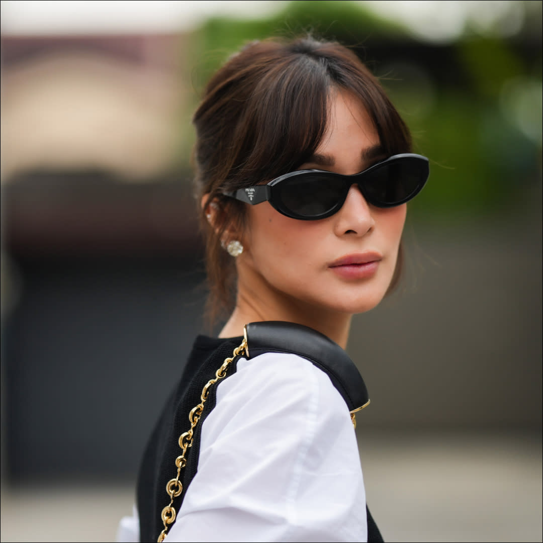  Heart Evangelista wears Prada sunglasses, a white shirt, during a street style fashion photo session, on November 18, 2023 in Manila, Philippines. 