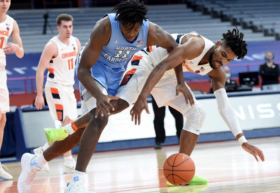 North Carolina Tar Heels forward Day’Ron Sharpe (11) and Syracuse Orange forward Quincy Guerrier (1) reach for a loose ball in a game between Syracuse and North Carolina at the Carrier Dome in Syracuse N.Y. March 1, 2021. Dennis Nett | dnett@syracuse.com