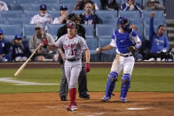 Washington Nationals' Andrew Stevenson, left, tosses his bat after striking out to end the sixth inning of a baseball game as Los Angeles Dodgers catcher Will Smith throws the ball Saturday, April 10, 2021, in Los Angeles. (AP Photo/Mark J. Terrill)