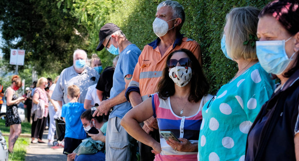 People waiting for coronavirus tests wearing masks.